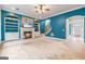 Open living room with fireplace, custom shelving, and entry to the main foyer at 1210 Magnolia Park Cir, Cumming, GA 30040