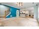 Open-concept living room showcasing staircase access and a view into the adjacent kitchen area at 1210 Magnolia Park Cir, Cumming, GA 30040