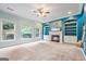 Bright living room with built-in shelves, a fireplace, and large windows offering natural light at 1210 Magnolia Park Cir, Cumming, GA 30040