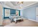Comfortable main bedroom featuring high ceilings, blue walls, neutral carpet, and plantation shutters at 1210 Magnolia Park Cir, Cumming, GA 30040