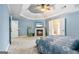 A spacious bedroom featuring a fireplace, a ceiling fan, and an ensuite bathroom at 1210 Magnolia Park Cir, Cumming, GA 30040