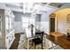 Spacious dining room with modern lighting, white wainscoting, and a patterned rug at 101 High Bluff Trl, Carrollton, GA 30116