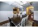Dining room with hardwood floors, decorative lighting, and view into a kitchen at 101 High Bluff Trl, Carrollton, GA 30116