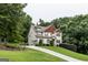 Charming home with a long driveway surrounded by mature trees, and a manicured front lawn at 101 High Bluff Trl, Carrollton, GA 30116