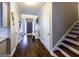 Hallway with hardwood floors leads to the front door and stairs at 101 High Bluff Trl, Carrollton, GA 30116
