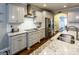 Modern kitchen with sleek gray cabinets, stainless steel appliances, granite countertops, and stylish backsplash at 101 High Bluff Trl, Carrollton, GA 30116
