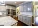 Spacious kitchen features gray cabinets, stainless steel appliances, granite countertops, and hardwood floors at 101 High Bluff Trl, Carrollton, GA 30116