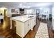 Stylish kitchen island featuring stainless steel sink, granite counters, white cabinets and seating in an open layout at 101 High Bluff Trl, Carrollton, GA 30116