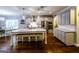 Elegant kitchen with stainless appliances, white cabinets, granite countertops and large central island for dining and prep at 101 High Bluff Trl, Carrollton, GA 30116