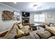 Spacious living room with gray sofa, decorative fireplace, and hardwood flooring at 101 High Bluff Trl, Carrollton, GA 30116