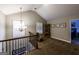 Bright loft area featuring a chandelier, built-in display case and shuttered windows at 101 High Bluff Trl, Carrollton, GA 30116