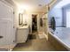 Bright main bathroom featuring double vanity sinks, shower, and soaking tub at 101 High Bluff Trl, Carrollton, GA 30116