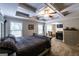 Spacious main bedroom featuring tray ceilings, fan, sitting area with a fireplace at 101 High Bluff Trl, Carrollton, GA 30116