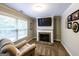 Sitting area showcasing fireplace, television, recliner, and a window at 101 High Bluff Trl, Carrollton, GA 30116