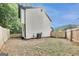 Exterior view of the back of the home with a wooden fence and grassy yard at 131 Turning Pt, Stockbridge, GA 30281