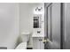 Bathroom features modern fixtures, a toilet, mirror, and a sink with white cabinets and gold fixtures at 131 Turning Pt, Stockbridge, GA 30281