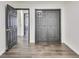 Bedroom features wood-look flooring, a double-door closet, and entryways to other rooms at 131 Turning Pt, Stockbridge, GA 30281