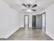 Large bedroom with a ceiling fan, wood-look floors, and entryways to other rooms at 131 Turning Pt, Stockbridge, GA 30281