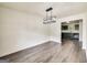 Spacious dining room with modern flooring, a contemporary light fixture, and open access to the kitchen at 131 Turning Pt, Stockbridge, GA 30281