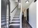 Bright entryway with a staircase, fresh paint, and wood-look flooring, creating a welcoming first impression at 131 Turning Pt, Stockbridge, GA 30281