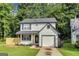 Charming two-story home features a classic white exterior, black shutters, and an attached one-car garage at 131 Turning Pt, Stockbridge, GA 30281