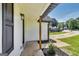 Inviting covered front porch with natural wood columns and black trim, leading to the home's entrance at 131 Turning Pt, Stockbridge, GA 30281