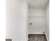 Bright laundry room features hardwood-style floors and convenient utility connections at 131 Turning Pt, Stockbridge, GA 30281