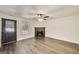 Comfortable living room showcases a fireplace, ceiling fan, and a door leading to the home's exterior at 131 Turning Pt, Stockbridge, GA 30281