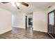Open living room with modern flooring, neutral walls, and an open doorway to a kitchen with green cabinets at 131 Turning Pt, Stockbridge, GA 30281