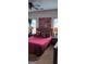 Bedroom with a plush red bed, decorative pillows, and ambient lighting on bedside tables at 2208 Crossrail Dr, Atlanta, GA 30349
