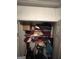 Shelf closet with clothes and boxes in a small space at 2208 Crossrail Dr, Atlanta, GA 30349