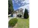 Charming two-story home with stone accents, a well-maintained lawn, and mature trees at 2208 Crossrail Dr, Atlanta, GA 30349