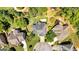 Aerial view of a house with mature trees and driveway in a landscaped community at 3400 Dencrest Se Ct, Smyrna, GA 30080