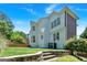 Landscaped backyard with retaining wall and view of home at 3400 Dencrest Se Ct, Smyrna, GA 30080
