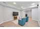 Spacious finished basement featuring modern flooring, lighting, seating and a television at 3400 Dencrest Se Ct, Smyrna, GA 30080