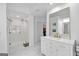Bright bathroom featuring marble floors, glass shower, and vanity with gold hardware at 3400 Dencrest Se Ct, Smyrna, GA 30080