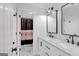 A bright bathroom featuring a double sink vanity with marble countertops and a walk in shower with patterned curtains at 3400 Dencrest Se Ct, Smyrna, GA 30080