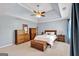 A spacious bedroom features a tray ceiling, ceiling fan, and wooden furniture creating a cozy atmosphere at 3400 Dencrest Se Ct, Smyrna, GA 30080