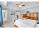 A well-lit bedroom has ample space and neutral decor, including wooden dressers and a comfortable bed at 3400 Dencrest Se Ct, Smyrna, GA 30080