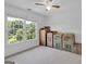 A clutter-filled bedroom with cardboard boxes and a large window with a view at 3400 Dencrest Se Ct, Smyrna, GA 30080