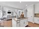Well-appointed kitchen with a center island cooktop, white cabinets, and open layout to the living space at 3400 Dencrest Se Ct, Smyrna, GA 30080