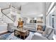 Bright and airy living room featuring a staircase, fireplace, and views of the kitchen at 3400 Dencrest Se Ct, Smyrna, GA 30080