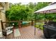 Open wooden deck area overlooking the backyard with a built-in grill and relaxing outdoor seating at 150 Sandy Ridge Trl, Fayetteville, GA 30214