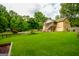 Spacious backyard with mature trees, a gazebo, and an in-ground pool, offering a private outdoor oasis at 150 Sandy Ridge Trl, Fayetteville, GA 30214