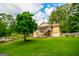 Well-maintained backyard showing the home's exterior, screened porch, and access to the in-ground pool at 150 Sandy Ridge Trl, Fayetteville, GA 30214