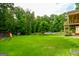 Expansive backyard featuring a play set, in-ground pool, and lush green lawn perfect for outdoor activities at 150 Sandy Ridge Trl, Fayetteville, GA 30214