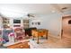 A finished basement featuring game tables, a large TV and a stone fireplace at 150 Sandy Ridge Trl, Fayetteville, GA 30214