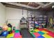 Basement with finished flooring, colorful gym mats, and storage for organization at 150 Sandy Ridge Trl, Fayetteville, GA 30214