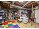 Unfinished basement with storage shelves and colorful playmat flooring at 150 Sandy Ridge Trl, Fayetteville, GA 30214