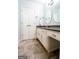 Bright bathroom features double vanity, oval mirrors, and neutral tile flooring at 150 Sandy Ridge Trl, Fayetteville, GA 30214